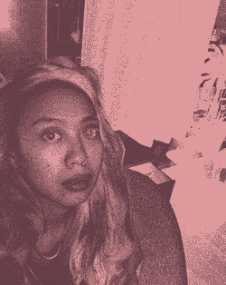 Pink gradient soaked animated gif of the designer Pamela Rosel sitting in her room in her faithful computer chair.